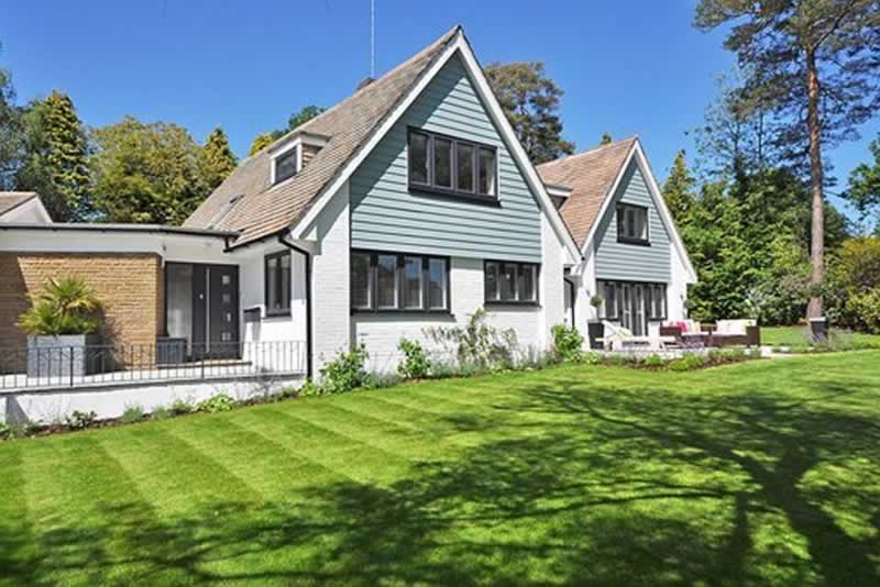 a beautiful home with a green lawn