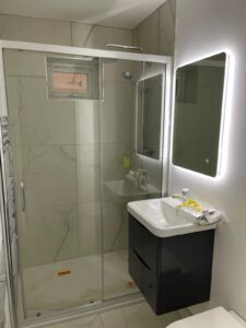 a lighting mirror with a sliding door